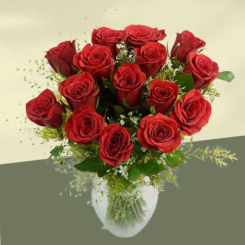 Striking Red Roses with Greens in a Glass Vase